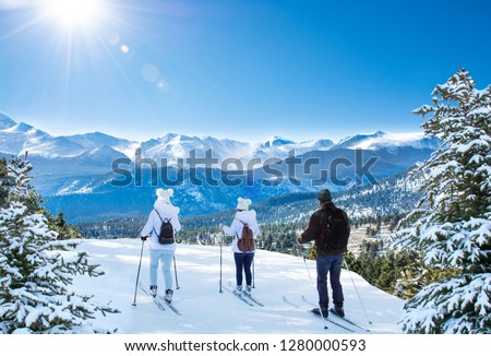 Active family skiing on winter vacation. Rocky Mountain National Park. Close to Estes Park, Colorado, USA Royalty-Free Stock Photo #1280000593
