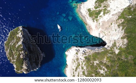 Aerial drone bird's eye view photo of tropical exotic mediterranean bay with white rock caves and deep turquoise clear sea