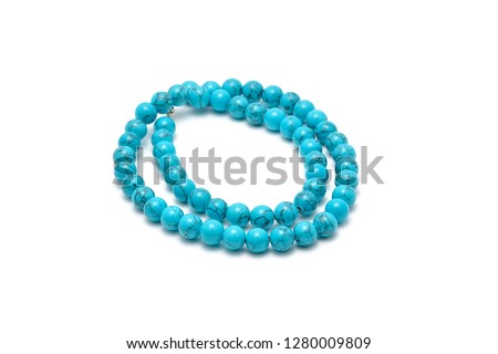 Blue semiprecious stone beads isolated on white background - close up Royalty-Free Stock Photo #1280009809