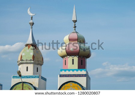 Domes decorated with colored paint, islamic signs on top