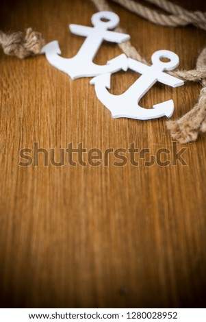 white decorative anchor on a wooden background