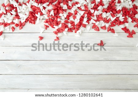 White and red flying hearts bright love passion frame border white wooden background. confetti love signs holiday. for Valentines Day decoration, empty space for text