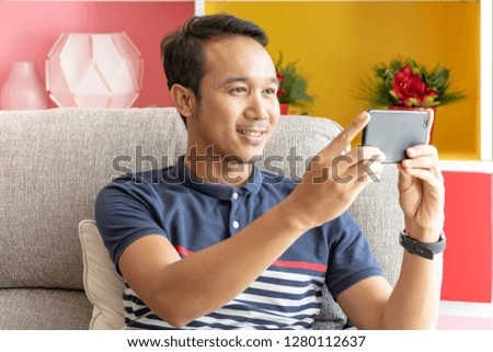 Man use interact application smartphone on sofa