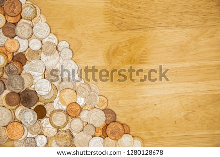 Coins of the United Kingdom sitting in a corner of a table with copy space.