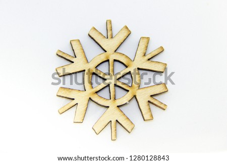 Single Decorational Snowflake Made of Wood Isolated Over the White Background. Christmas tree decor.