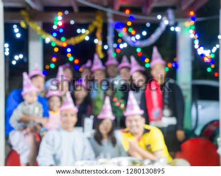celebration, family, holidays and birthday concept - by anyone wearing a pink hat. Image blur.