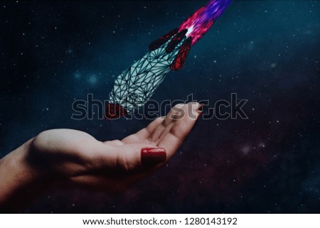 Human hand holding Rocket. Nebula dust. Mixed media.