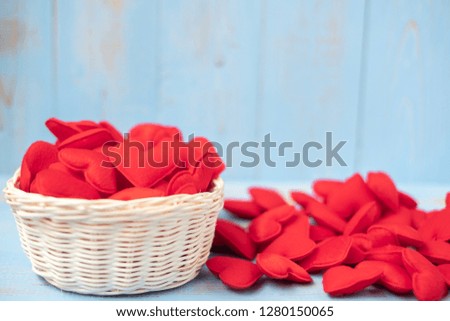 red heart shape decoration in basket on blue wooden table background. Love, Wedding, Romantic and Happy Valentine’ s day holiday concept