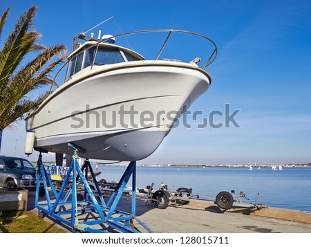 boat on repair in dry dock Royalty-Free Stock Photo #128015711