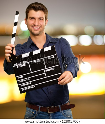 Happy Young Man Holding Clapboard, Outdoor