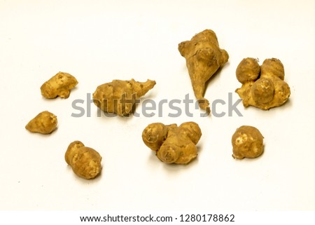 A picture of Jerusalem artichokes - also known as sunchokes- on a white background 