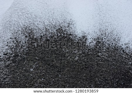 black white background of ash and snow outside