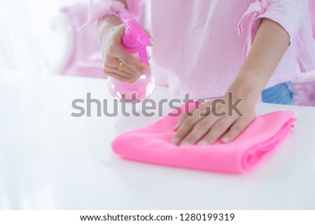 Asian woman cleaning the floor in the living room