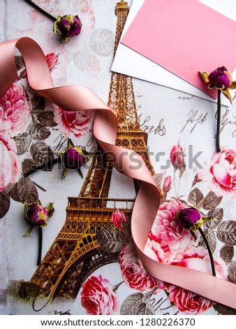 gift box with a picture of the Eiffel Tower. flowers, perfume bottle and ribbon