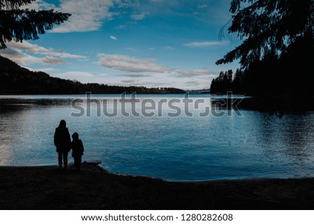 two silhouettes looking at Nahuel Huapi lake in Patagonia Argentina