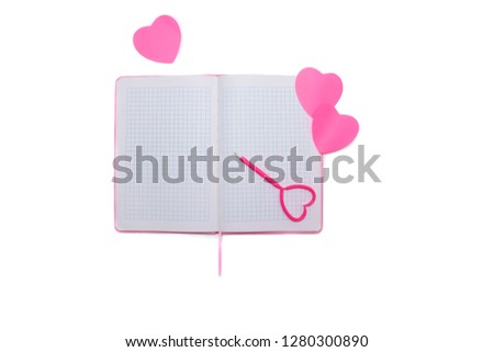 Pen on a white sheet of paper on an open notebook with hearts on a white background. Set for writing a love letter for Valentine's Day.