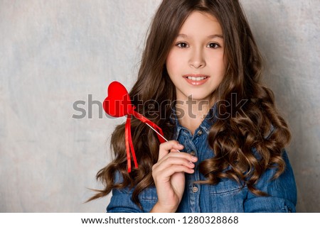 Valentine's Day. Beautiful girl with red heart.
