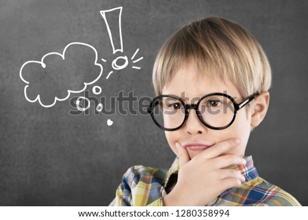 Portrait of a cute young boy with glasses isolated on  background. Studio shot. Royalty-Free Stock Photo #1280358994