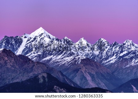 Scenic view of Snow cladded Panchchuli peaks falls in great Himalayan mountain range alpine at sunset enroute to Khalia Top trekk trail at small hamlet Munsiyari, Kumaon region, Uttarakhand, India. Royalty-Free Stock Photo #1280363335