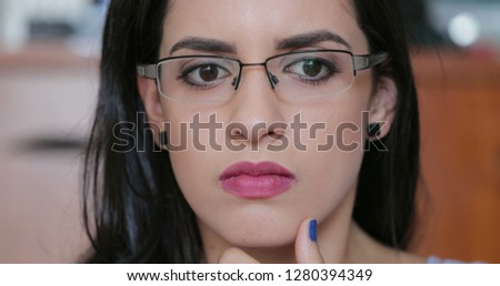 Hispanic Girl face looking at computer screen with an intrigued, surprised, and shocked emotion