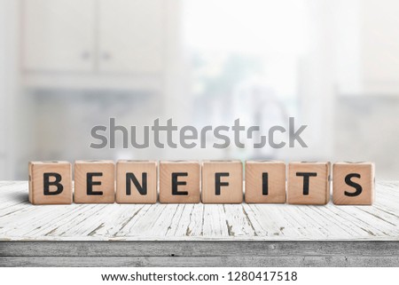 Benefits on a worn table in a bright room made with wooden blocks Royalty-Free Stock Photo #1280417518