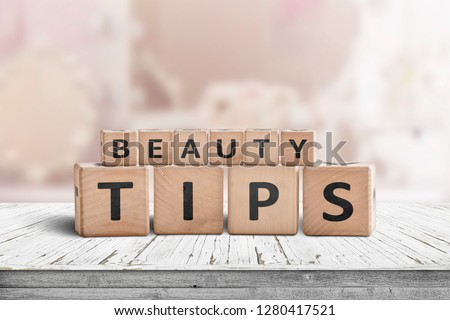 Beauty tips sign on a makeup table in a bright powder room with a pink tone
