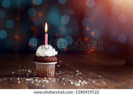 Creative background, cupcake with candles, beautiful bokeh. Happy Birthday. Present. Concept for Holiday Card, Flyer, Background. Copy space