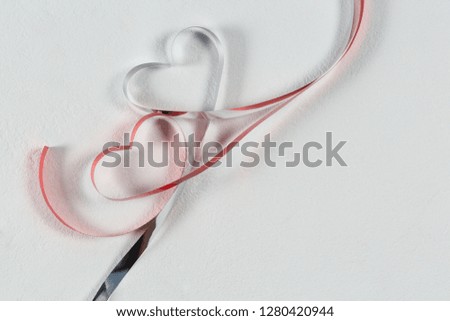 Close-up of heart shape ribbons on white background