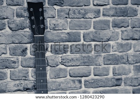 The details of a folk guitar shot in different perspectives are revisited in a monochromatic interpretation of the shots.