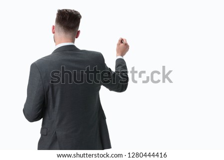 rear view.businessman writing on an invisible Board