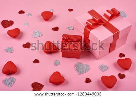 Gift box on pink background made hearts. Valentine background.