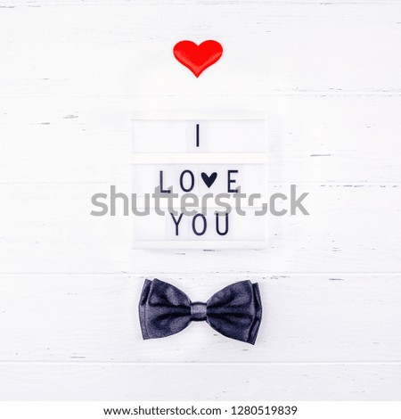 Creative Valentine Day romantic composition flat lay top view love holiday celebration black bow tie lightbox white wooden background copy space Template greeting card text design social media blogs