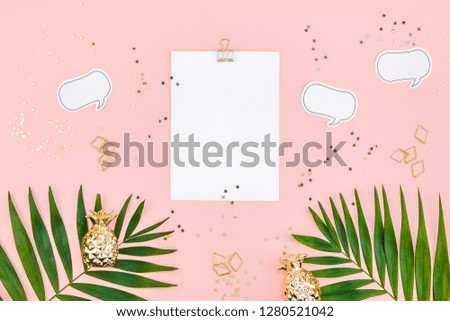 Creative flat lay top view mock up blank paper sheet postcard clip board green tropical palm leaves on millennial pink paper background copy space. Minimal tropical palm leaf plants summer concept