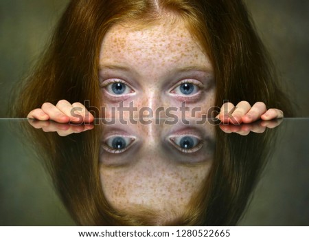 Girl is hiding under mirror.