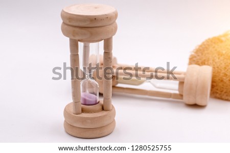 The hourglass put on background,blurry light around,sign and symbol of forever love