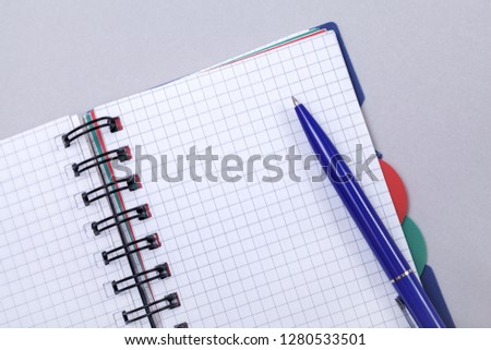 Overhead photo of an open journal notebook with a pen, top view, a diary on a gray background with a place for text