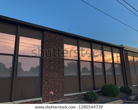 Picture of building, sky reflected in windows