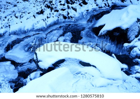 Winter. Fast mountain stream                               