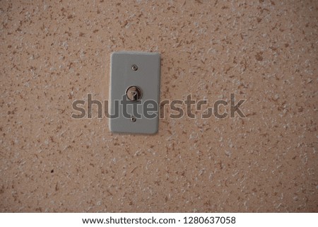 elevator button close up orange wall