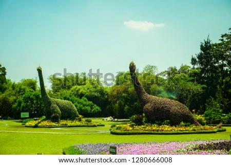 brontosaurus replica statue made from natural green forest and tree with clear sky - photo indonesia Royalty-Free Stock Photo #1280666008