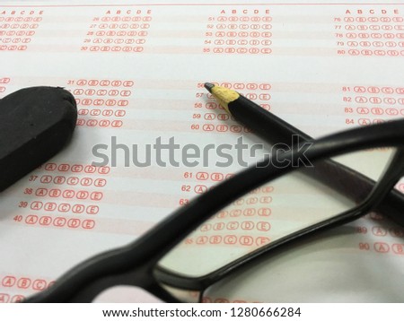 Picture of pencil, eraser and glasses on the OMR sheet.