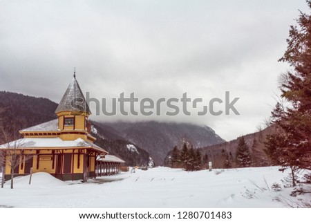 an overcast snow filled abadoned railroad station