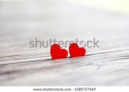 Two wooden hearts on wooden background. Concept of Valentines Day. Close up.