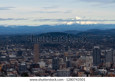 Cityscape of Portland Oregon with amazing clouds and Mount Hood in a distance in Oregon