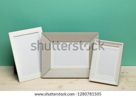 frames on  desk near green wall