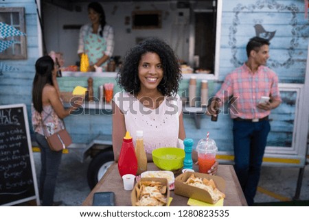 Portrait of beautiful woman sitting at table in cafeteria