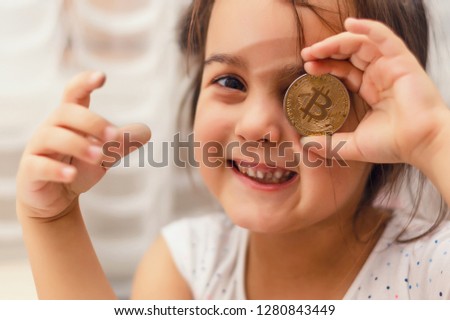 little girl with bitcoin on the eye