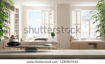 Wooden vintage table shelf with pebble balance and 3d letters making the word feng shui over modern white and wooden kitchen in contemporary apartment, zen concept interior design, 3d illustration
