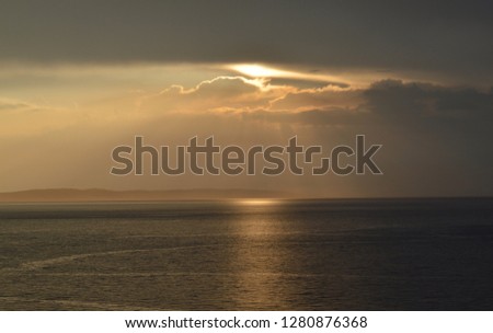 Sun beams passing through clouds after storm