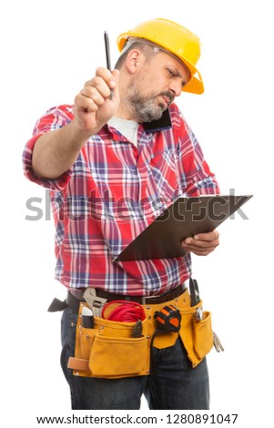 Male builder with focused expression holding pen up as do not disturb sign isolated on white studio background